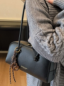 Vintage black lychee leather pillow bag with gold lettering and pretzel charm for women