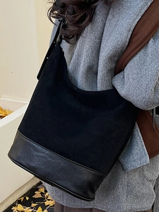 Retro black suede and leather large shoulder bag for women on model in winter