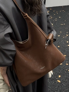Large dark brown hobo shoulder bag with white logo and small matching accessory pouch