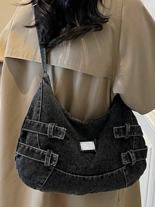 Chic black denim hobo bag with adjustable metal buckle straps and silver logo plate