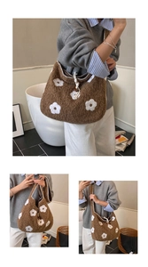 Detail of soft brown plush tote bag featuring white floral embroidery and shoulder strap