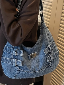 Retro denim hobo shoulder bag with silver buckle straps and a vintage washed blue finish