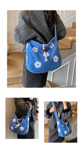 Detail view of blue plush tote bag featuring large white flower and wooden horn button