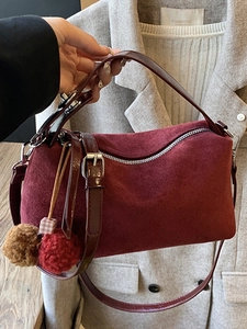 Retro burgundy suede underarm bag with plush charm and adjustable shoulder strap