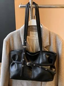 Classic black faux leather tote bag with stylish wrap-around buckle straps for daily commute