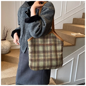 Detail of green-brown plaid tweed tote bag with Bonne Journee embroidery on front
