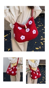 Detail of red plush tote bag with white floral embroidery and white drawstring