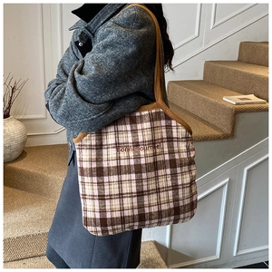 Detail of vintage plaid tote bag with Bonne journée embroidery and woven straps
