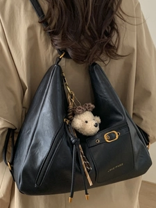 Minimalist black large capacity tote bag in soft leather with a plush bear charm for women