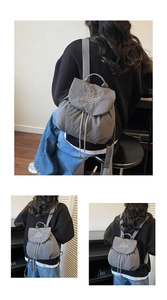 Detail of grey bubble texture fabric and white letter embroidery on drawstring backpack