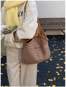 Close-up of a plaid tote bag with teddy wool lining and the journey embroidery details