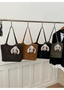 Detail view of retro tote bags in four colors with suede texture and rabbit charms
