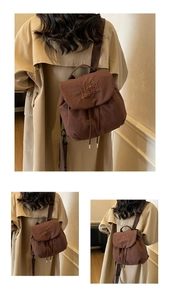 Detail showing the brown textured fabric and YOU+ JIBEAR embroidery on the drawstring bag
