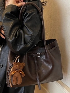 Vintage dark brown large tote bag with pleated leather texture and a cute plush bear charm