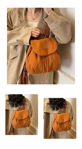 Detail of caramel drawstring backpack featuring waffle texture and embroidered text