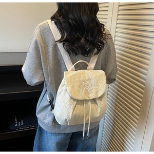 Detail of Korean style drawstring backpack with bubble texture and YOU BEAR embroidery