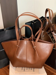 Minimalist large brown wing-shaped tote bag with dual handles in stylish PU leather