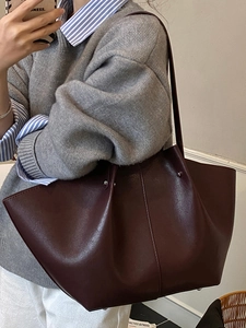Minimalist burgundy matte leather tote bag for women with trapezoid shape and studs