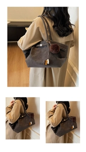 Detailed macro view of dark brown suede tote bag with decorative plush ball and wooden beads