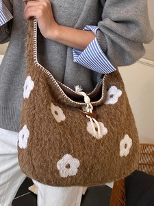 Brown fleece tote bag with white flower embroidery and toggle drawstring closure