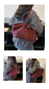Detailed close-up of dark red suede tote bag with brown pom-pom and wooden bead charm