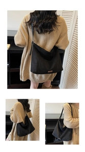 Detailed back view of a large black suede tote bag showing its slouchy crescent shape