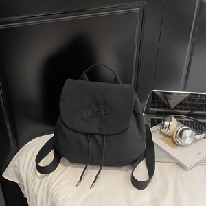 Detail of black drawstring backpack with You Jibear embroidery on the nylon cover