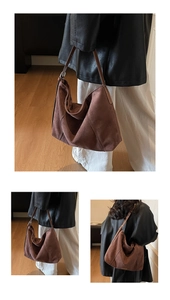 Detail shot of large brown suede hobo bag with adjustable leather strap and metal buckle