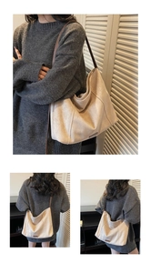 Close-up of beige suede tote bag with brown straps and fine metal logo detail