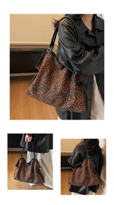 Close-up of leopard print canvas tote bag with black embroidery and leather straps