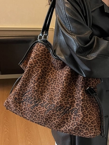 Minimalist leopard print tote bag with black leather handles and embroidered logo