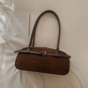 Close-up of vintage dark brown frosted suede baguette bag with buckle detail