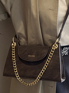 Elegant dark brown leather crossbody bag with stylish gold chain and textured finish
