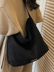 Minimalist large black suede tote bag for women showing spacious daily commuter hobo design