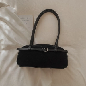 Detail of vintage matte black Boston bag with double leather straps and silver buckle