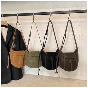 Detailed row of matte suede bucket bags in multiple colors with white contrast stitching