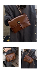 Close-up of retro dark brown crossbody bag with pleated texture and stylish metal chain