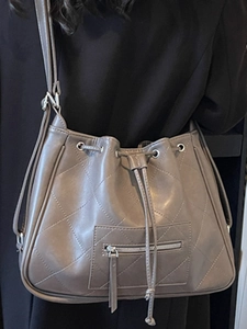 Retro taupe quilted bucket tote bag with drawstring closure for winter commuters