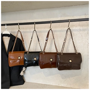 Detail showing variety of vintage flap bags with metal chain straps in neutral colors
