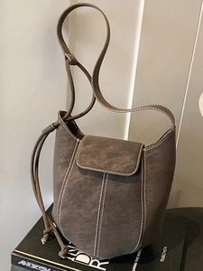 Minimalist dark brown matte suede bucket bag with stylish contrast white stitching