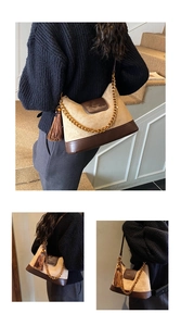 Detail of a retro stitching shoulder bag with gold chain and dark brown leather tassel