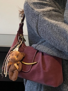 Chic burgundy pleated underarm bag with crescent metal buckle and cute bear charm