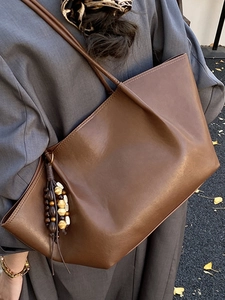 Vintage brown oil wax leather tote bag with boho tassel detail for autumn fashion