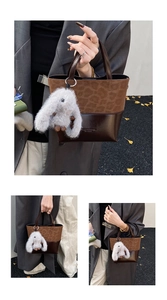 Detail of leopard print patchwork shoulder bag with a cute plush bunny charm