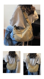 Detail view of khaki nylon dumpling bag with adjustable strap and braided zipper pull
