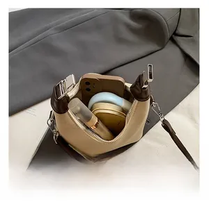 Top view of mini canvas bucket bag interior showing capacity for phone and cosmetics