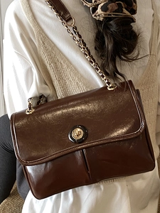 Vintage dark brown waxed leather crossbody bag with gold chain strap and metal lock