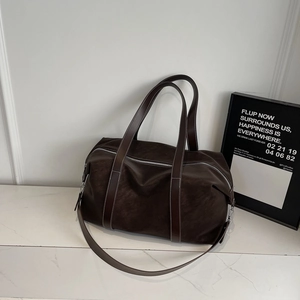 Gros plan détaillé du sac cabas en similicuir marron foncé avec surpiqûres blanches