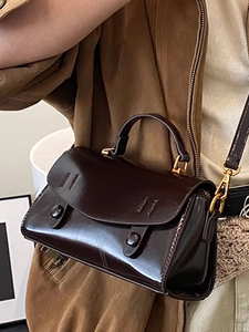 Borsa quadrata minimalista in pelle lucida marrone scuro con dettagli dorati e tracolla