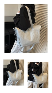 Detailed view of large capacity grey tote bag with side pockets and adjustable shoulder strap